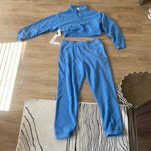 Aritzia track suit in blue. Top is size M and bottoms are size L. New with tags